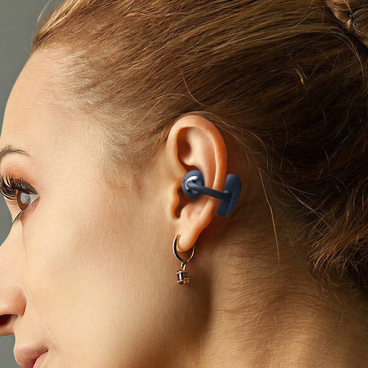 Close-up concept view showing a graphite vivolight earphone clipped around the outer ear.